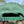 Green perforated cap with a brand logo on a blurred natural background